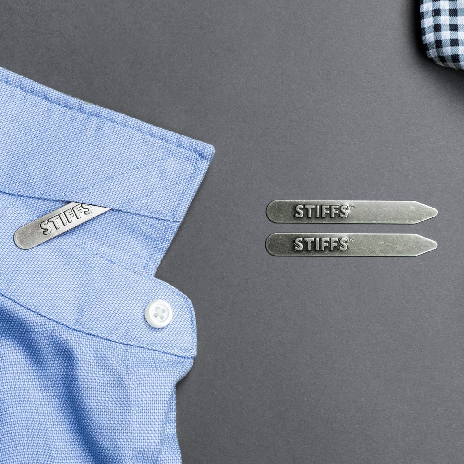 Two collar stays inserted into a blue dress shirt keep the collar looking crisp and sharp.