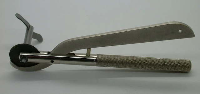 The mechanism of the vintage ring cutter, with a smooth cutting wheel and ergonomic handle