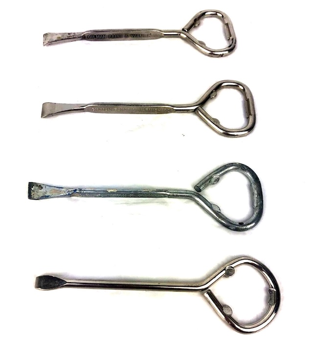 A collection of four vintage paint can openers, each showcasing unique wear patterns, suggesting the stories and countless paint jobs they have witnessed