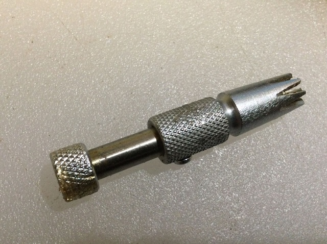 Another view of the vintage nose hair trimmer, highlighting its textured grip and small cutting blades.