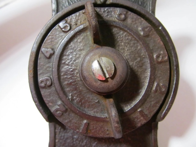 A close-up of the dial used to adjust the furnace's temperature settings, featuring clearly marked numbers.