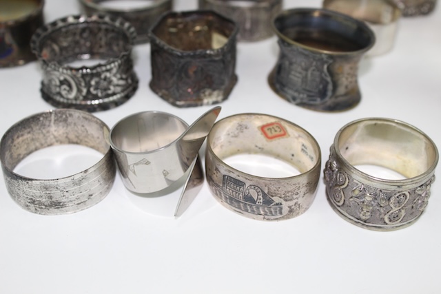 A closer look at a few unique vintage silver napkin rings, revealing intricate engravings and subtle wear that adds to their charm and antique allure.