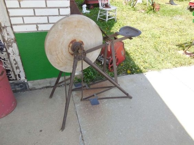 The antique tool sharpener powered by foot pedals, a reminder of hands-on craftsmanship