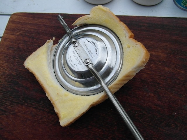 The Nutbrown sandwich toaster at work, pressing a sandwich to create a crispy, golden-brown treat.