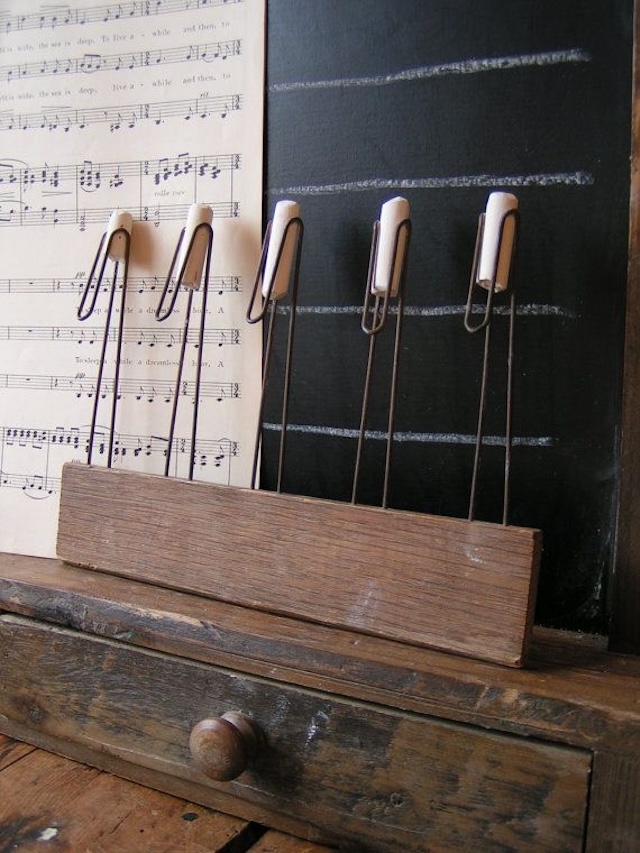 The vintage chalk holder displayed next to a chalkboard, evoking nostalgia and showing its classic use in an educational setting