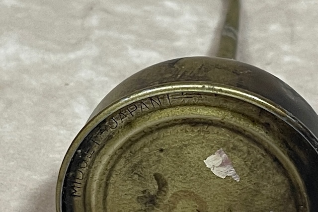 Close-up view of the bottom of the vintage midget oil can dispenser, proudly stamped with "Made in Japan," signifying its origin and authenticity