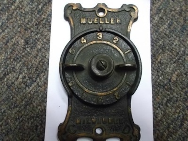 This well-preserved cast iron furnace dial plate showcases the enduring build quality and aesthetic of vintage heating tools.