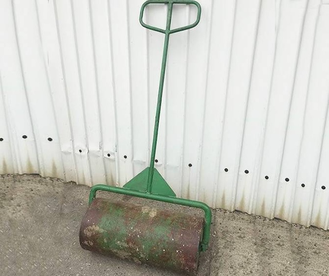 A compact yet effective tool used to ensure an evenly leveled lawn, often used in home gardens.