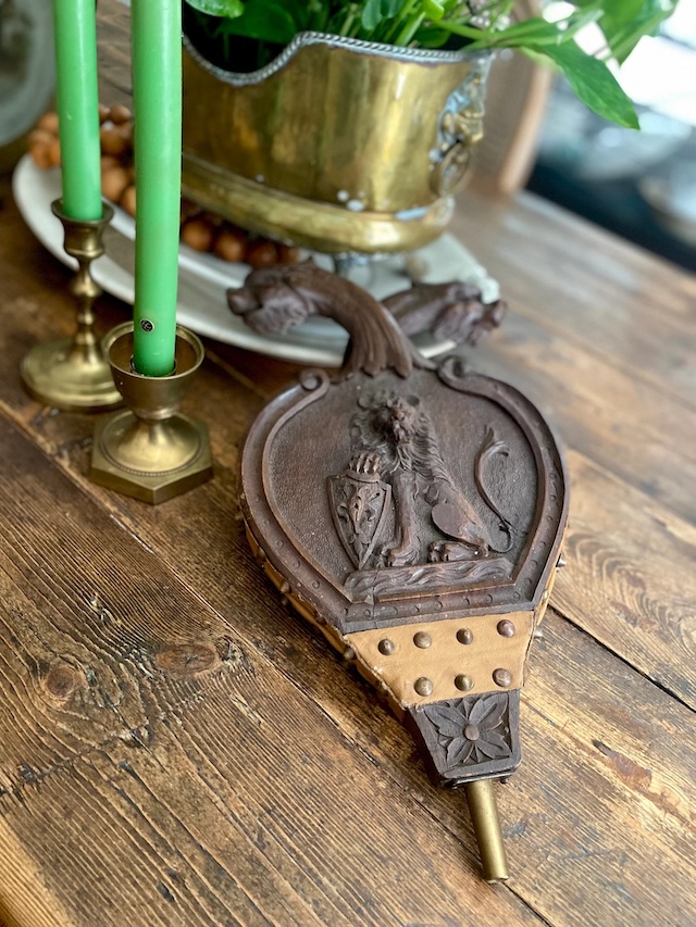 A royal-themed bellows, carved with a lion motif, showcasing the artistry of antique home accessories