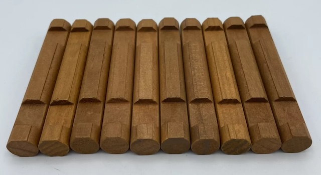 A batch of Lincoln Logs wooden pieces in their traditional light brown finish, offering endless possibilities for imaginative construction