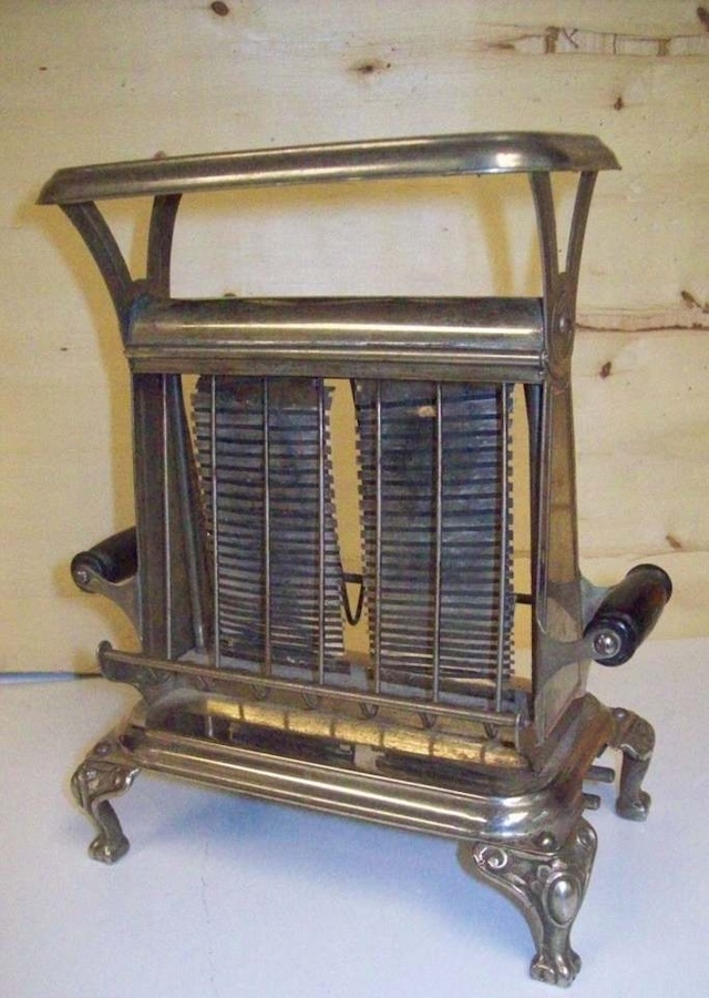 An elegant and ornate vintage toaster with detailed craftsmanship, reflecting the style and utility of early kitchen appliances.