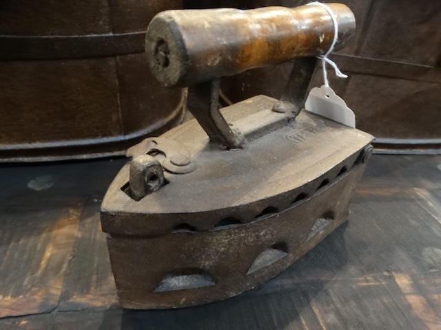 Showing signs of age and use, this iron still holds the charm of a bygone era when clothing care required manual effort.