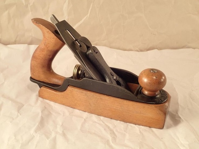 The smooth curve of the handle and sturdy iron blade on this classic Stanley plane speaks to its role in fine furniture making and cabinet work