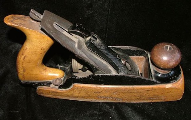 A well-preserved Stanley wood plane, once essential for woodworkers, now a collector's item displaying its aged yet functional beauty