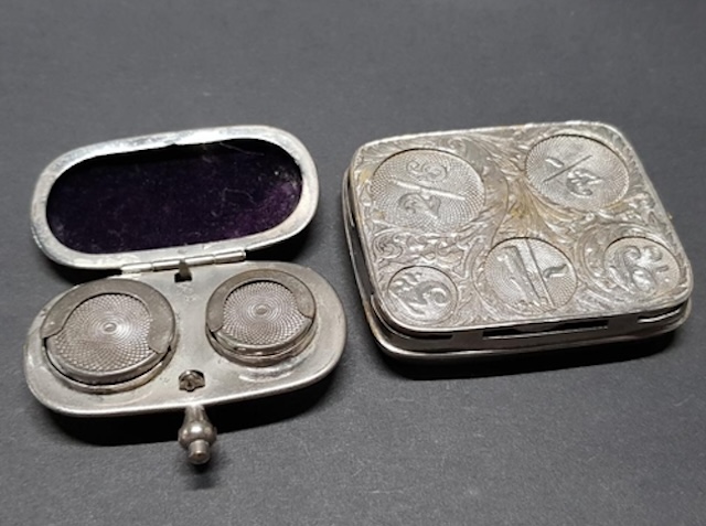 A pair of vintage sovereign holders, each with unique engravings, reflecting the artistry and functionality of a bygone era.