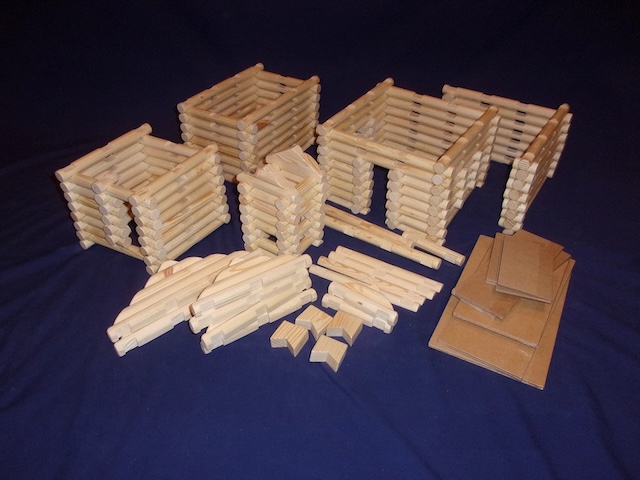 A set of Lincoln Logs wooden building kits ready for assembly, allowing for the creation of multiple types of cabins and structures