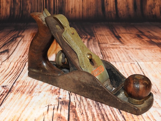 This pair of vintage wood planes, side by side, tells a story of countless hours spent smoothing and refining woodwork in workshops of the past