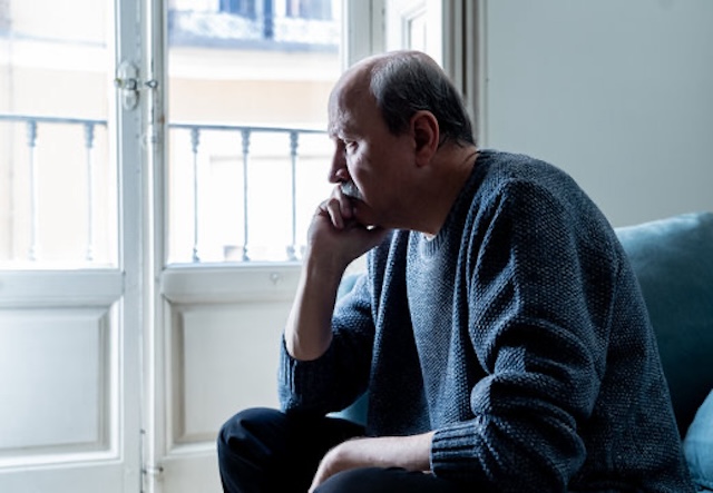 Gregory sits by the window, deep in thought, unaware that life is about to surprise him in an incredible way