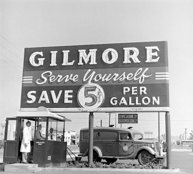 This large sign at Gilmore Gas Station highlights how Americans began to experience the convenience and cost savings of pumping their own gas—a novel concept for its time