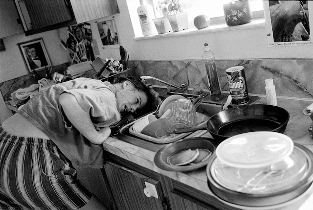 Everyday struggles—captured in the chaos of a kitchen. The exhaustion is palpable, as even the simplest chores can feel overwhelming in the messiness of real life