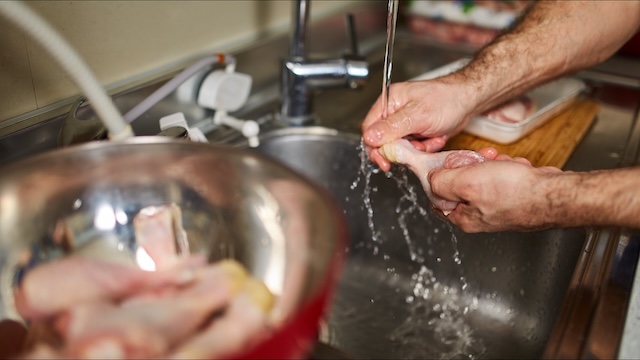 A common kitchen practice: rinsing raw chicken in the sink, which sparks debates about food safety