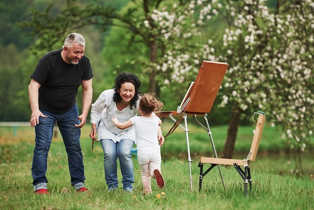 Enjoying a peaceful picnic together, the grandfather and grandson share a quiet afternoon, savoring each other's company