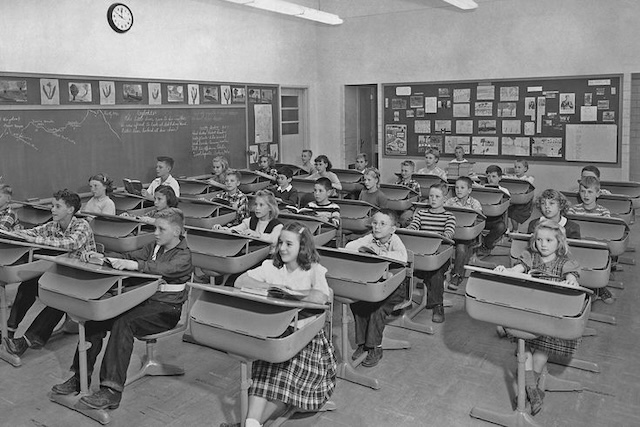 A 1950s classroom, showing the structured, post-war approach to learning with rows of attentive students