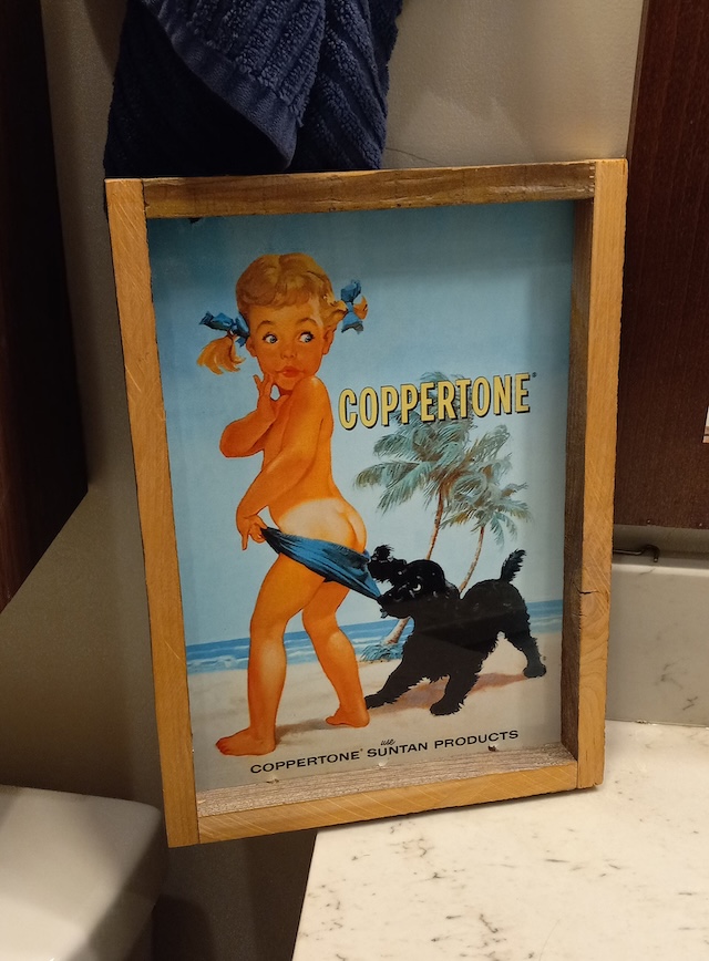 A framed vintage Coppertone ad featuring the famous girl and her dog still evokes nostalgia for simpler summer days