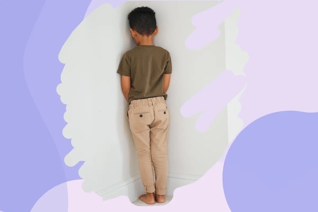 A modern take on the time-out method, with a child standing in the corner as part of a gentler approach to discipline, highlighting how this technique is still used today but in more emotionally supportive contexts