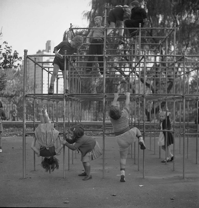 Children climb and dangle from jungle gyms, proving that heights and risky adventures were an everyday part of playtime back in the day