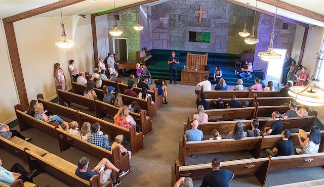 A congregation gathering, each individual expressing faith in their unique way, raising questions on modern church customs and attire