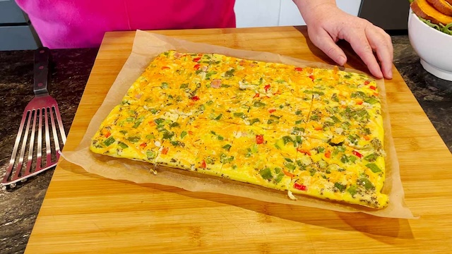 This large sheet omelet is prepped for cutting and freezing, providing an easy way to store and serve breakfast throughout the week