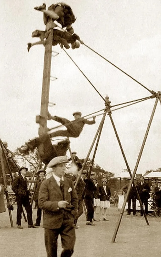 Young boys defy gravity on a homemade wooden swing, with little concern for safety. It was all about the thrill of the moment!