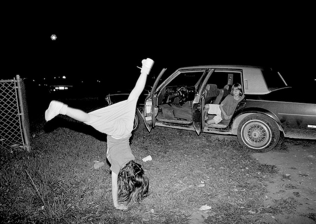 A nighttime car ride turns into an impromptu performance, as a girl flips through the dark with the moon as her audience