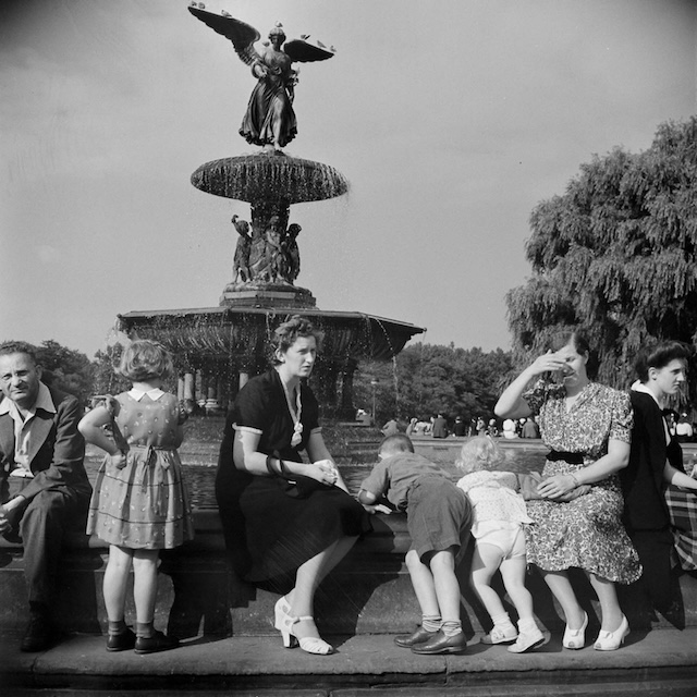 Families and children gather around the Bethesda Fountain in Central Park, a place of rest and reflection. The beautiful fountain serves as a reminder of the park’s role in offering a serene escape within the city