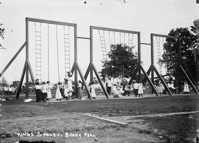 Children climb and swing on poles and rings in Bronx Park, showing that physical activity and adventure were key elements of fun even in the early 20th century