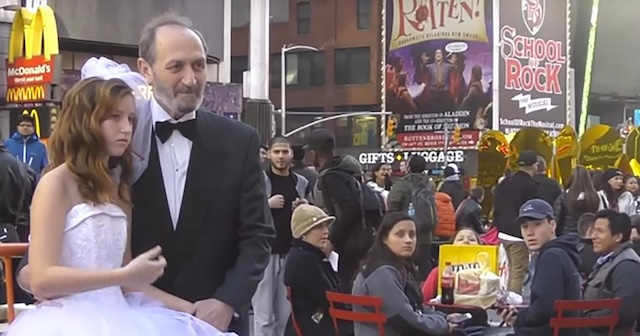 The fake wedding between the child bride and elderly groom continues in the busy streets of Times Square, as curious and concerned passersby look on in disbelief