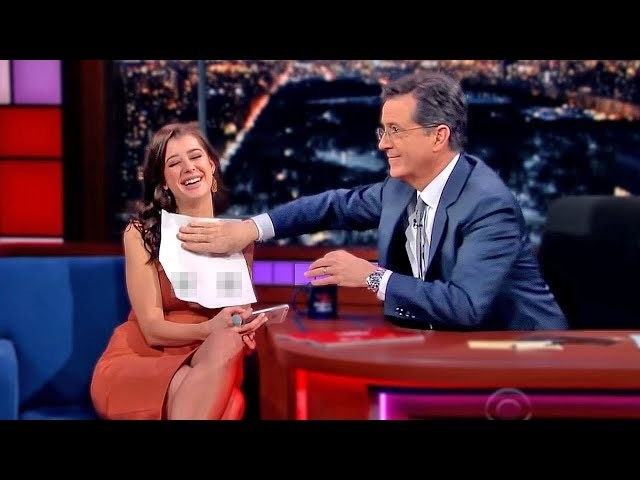 A lighthearted moment on a late-night show where the host playfully interacts with a guest, capturing the spontaneous and fun nature of live TV entertainment