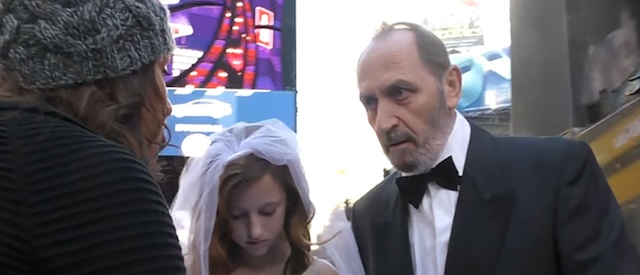 A passerby confronts the elderly groom, expressing outrage and disbelief, while the young bride remains silent during the controversial social experiment on child marriage