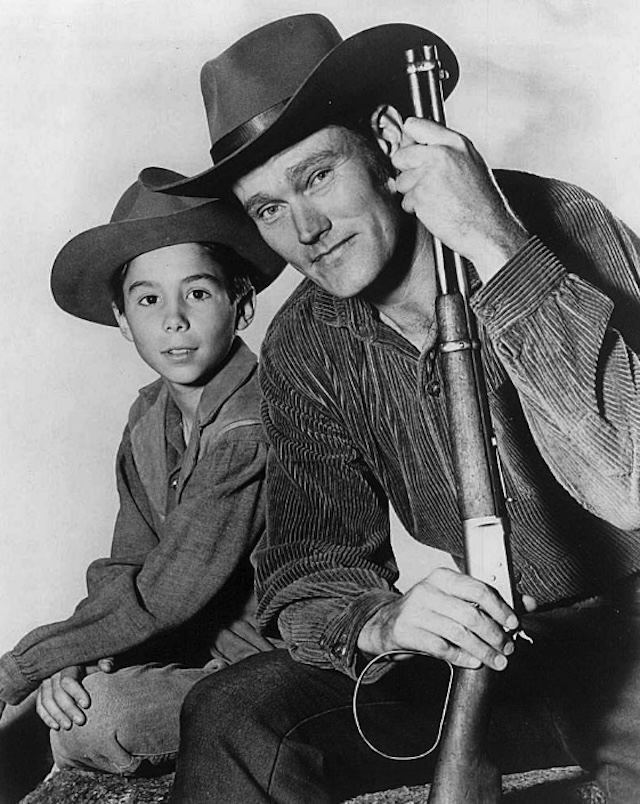 Lucas McCain and his son Mark, portrayed by Chuck Connors and Johnny Crawford, ready for another adventure in The Rifleman, a classic Western series filled with action and family values