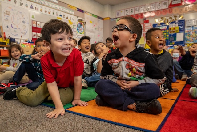 Children enjoying themselves in a classroom setting, a reminder that safety measures should promote both physical safety and emotional well-being