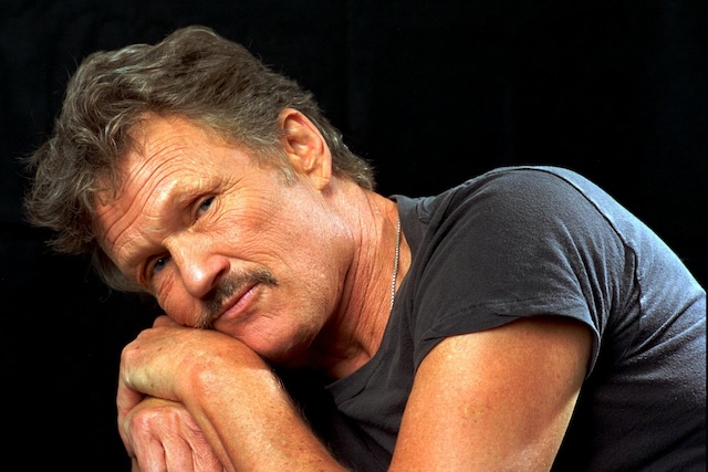 A younger Kris Kristofferson in a contemplative pose, capturing the soulful, rebellious spirit of his early career