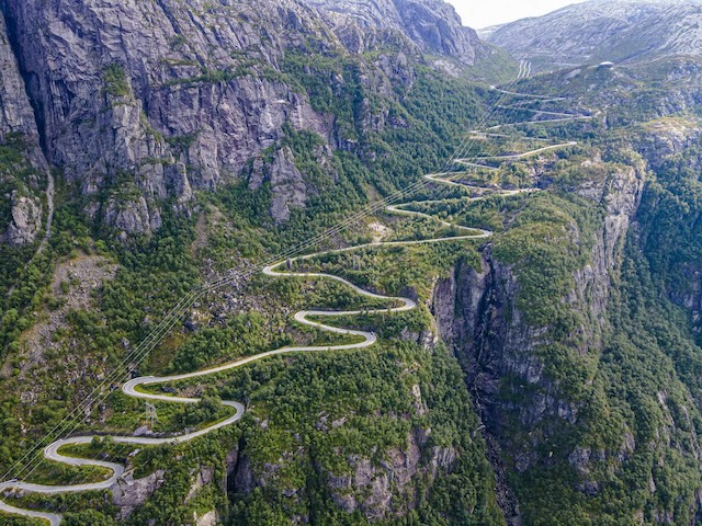 Though it may seem longer, a winding road keeps vehicles manageable and drivers focused, reducing fatigue on steep inclines