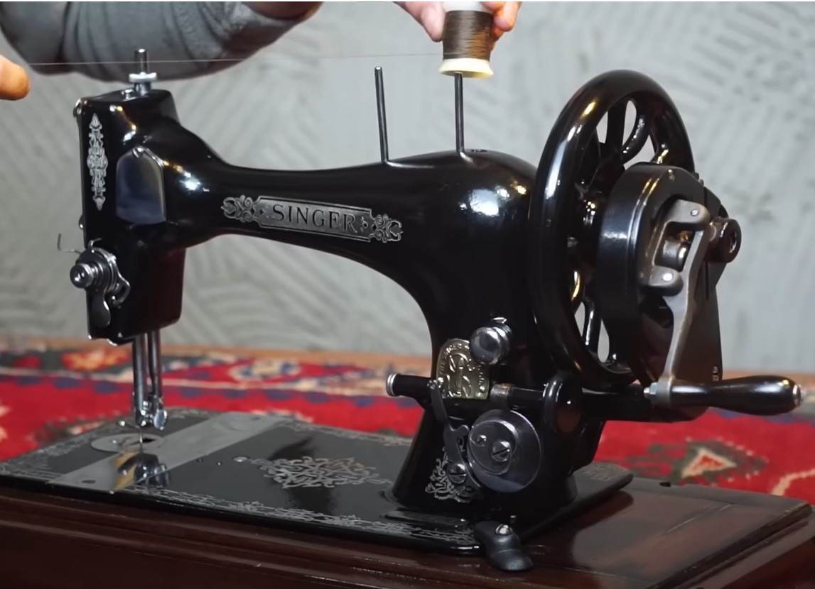 The Singer sewing machine, fully restored to its original brilliance, now gleams with its iconic black and gold design, ready to sew once again with precision.