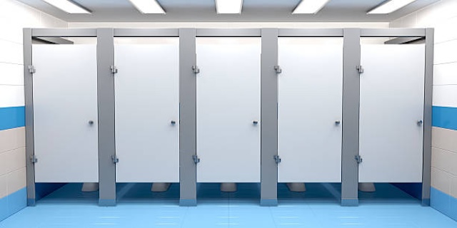 Row of public bathroom stalls – This design offers a balance between privacy and practicality, especially in high-traffic areas