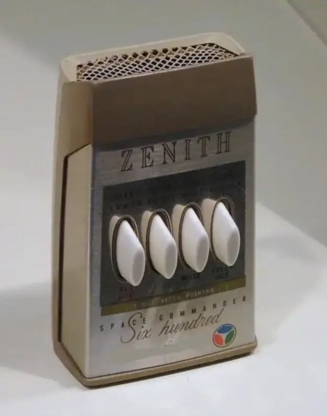 A close-up view of the classic Vintage Zenith Space Commander Six Hundred TV remote control, with its iconic four buttons used for channel, volume, mute, and tint adjustment