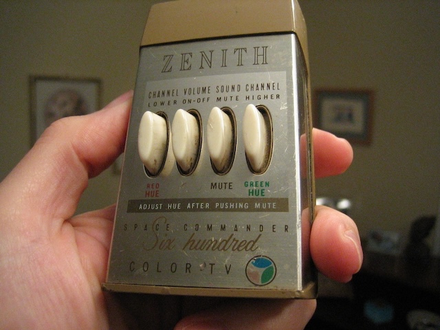 Holding the Vintage Zenith Space Commander Six Hundred TV remote, a glimpse into mid-century television convenience, showcasing the large buttons designed for easy control