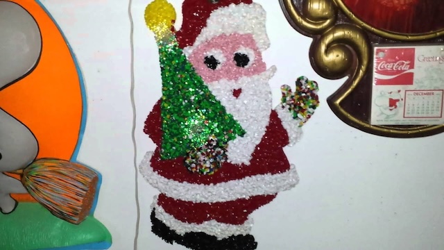 Festive Santa Claus brings the holiday spirit with this colorful melted plastic popcorn decoration, perfect for the wall during Christmas celebrations