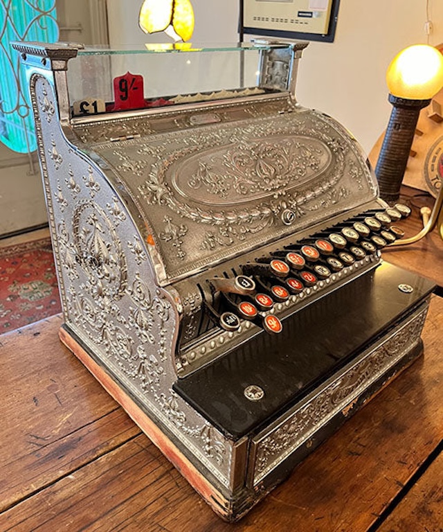 Another stunning example of a vintage mechanical cash register, highlighting its ornate design and functional beauty that made it an essential tool for shopkeepers