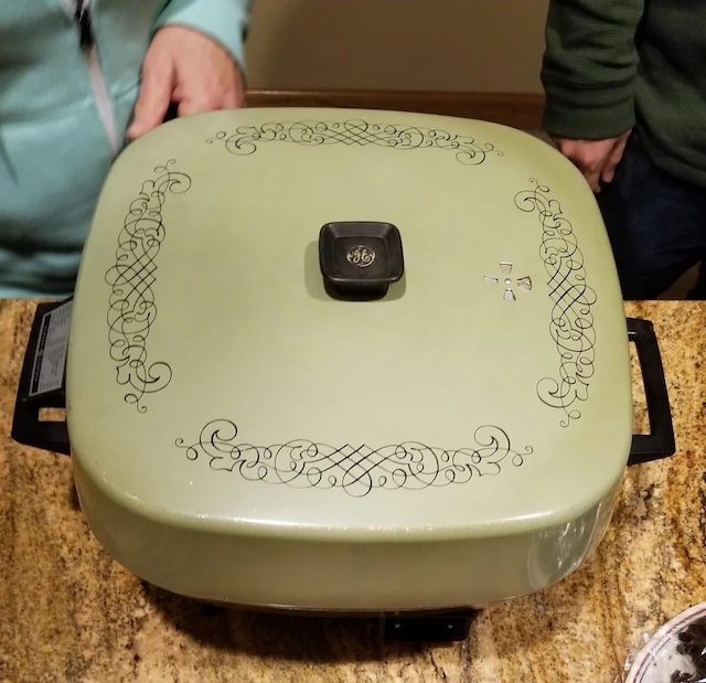 The beautiful detailing on the lid of this vintage electric skillet adds a touch of elegance to its practical use. Once a staple on kitchen counters everywhere